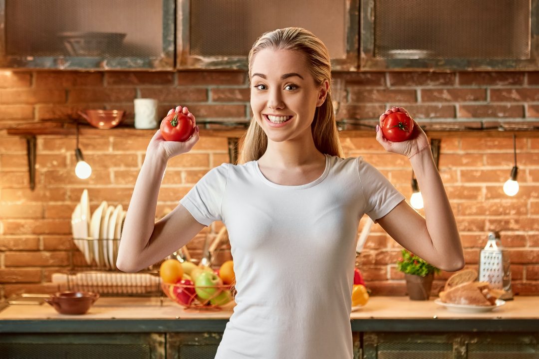 veggies-don-t-cause-wedges-happy-young-woman-cutting-fresh-vegetables-in-modern-kitchen-cozy.jpg